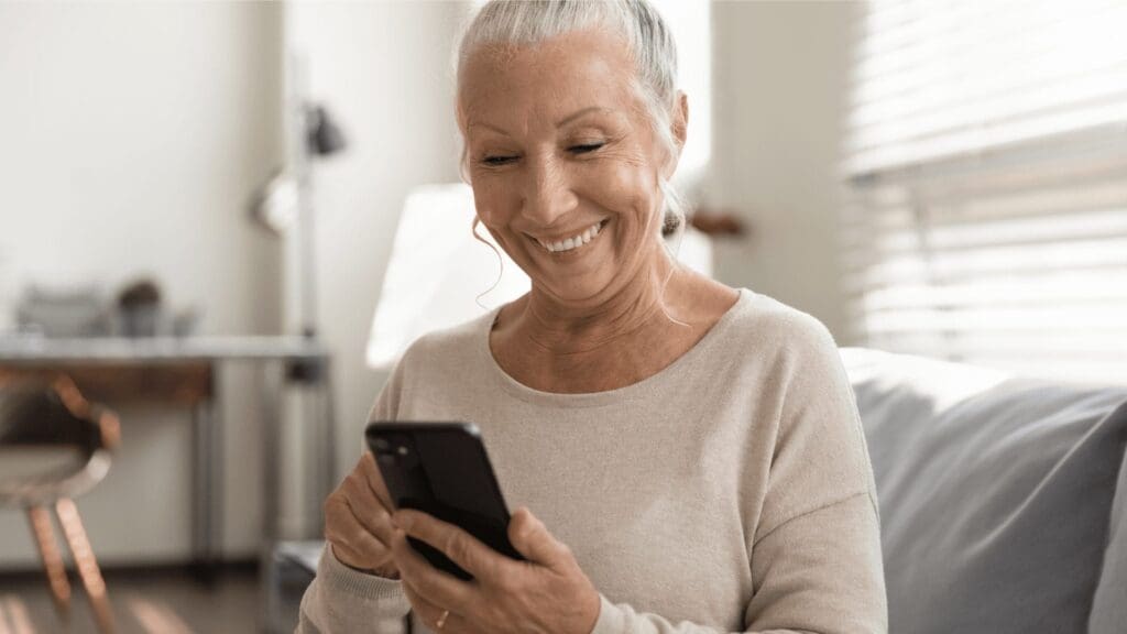 social media- Woman smiling on phone | Checking Holiday Lists