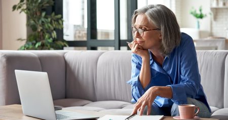 older woman doing research on her computer