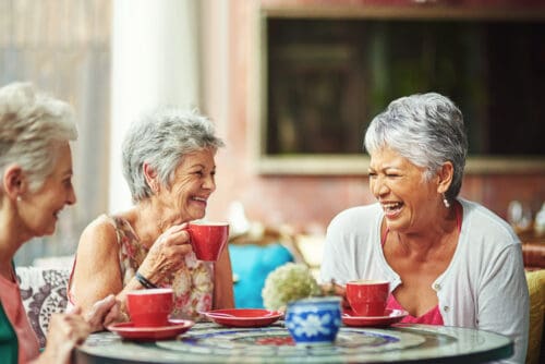 Senior Positivity - 3 senior females sitting at a table drinking coffee | Social Activities